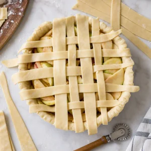 Lattice strips arranged over the apple pie filling.