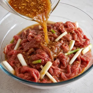 Pear soy marinade poured over sliced beef and green onions