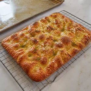 Baked Roman-style pizza bianca cooling on a wire rack until crisp and golden