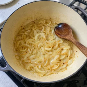 Sliced onions sauteing in coconut oil until translucent and golden.