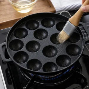 Khanom khrok pan heated and brushed lightly with vegetable oil