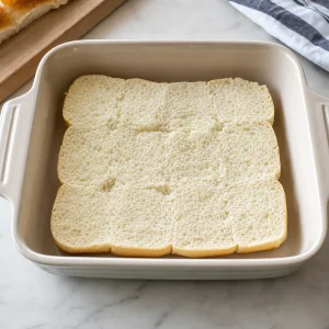 Roll bottoms placed cut side up in the baking dish