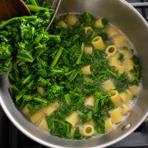 Broccoli rabe added to boiling pasta