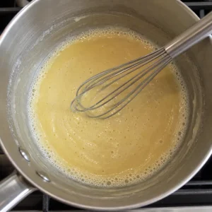 Pale roux whisked in a saucepan