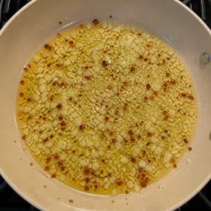 Garlic and red pepper flakes sizzling in olive oil