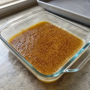 Browned butter cooling in a shallow glass dish