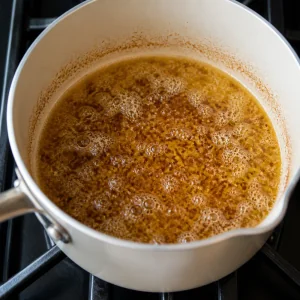 Brown butter bubbling in a light-colored saucepan