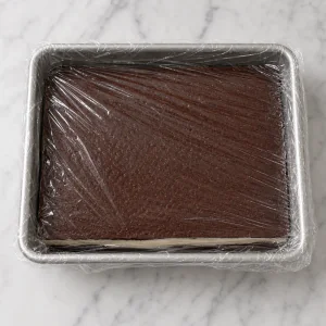 Assembled brownie ice cream slab wrapped for freezing