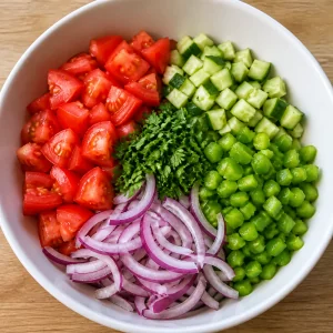 Pepino, pimentão verde, cebola e salsa adicionados aos tomates