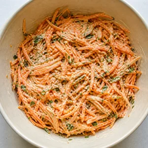 Grated carrot salad coated with creamy tahini dressing