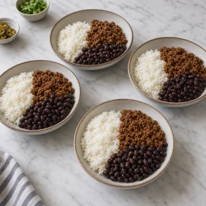 Rice seasoned beef and black beans divided into serving bowls