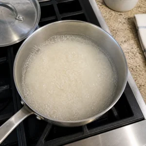 Jasmine rice boiling in water in a saucepan