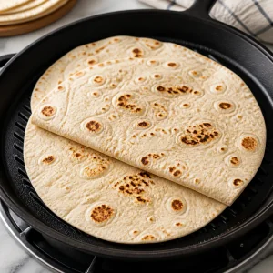 Flour tortillas warming with light char marks