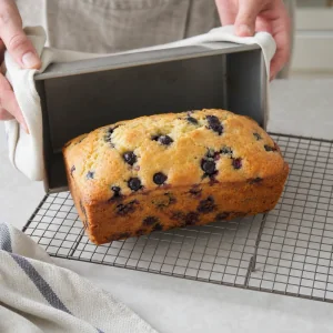 Blueberry lemon loaf transferred to a wire rack to cool