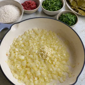 Onion and garlic sautéing in olive oil for dolma filling.