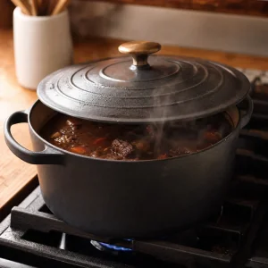 Covered Dutch oven gently simmering beef stew on low heat.