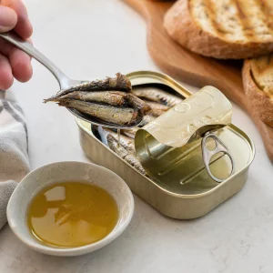 Canned sprats drained from their oil with a little oil reserved