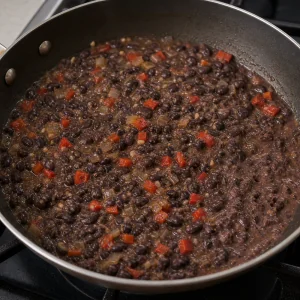 Black beans simmering in a thickened sauce