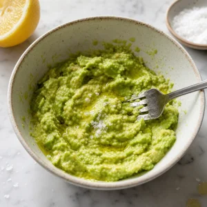 Chunky mashed avocado with lemon in a bowl