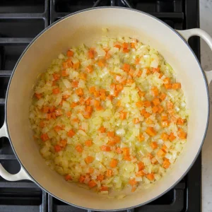 Onion and carrot sauteing in butter and olive oil until softened.