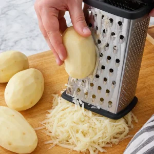 Peeled russet potatoes grated into long shreds with a box grater