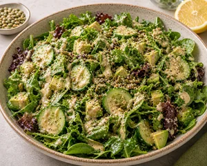 Green salad drizzled with creamy lemon tahini dressing