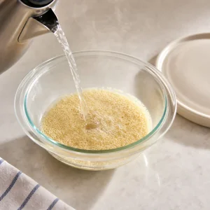 Boiling water being poured over couscous