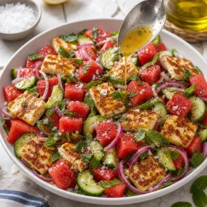 Finished salad topped with dressing and flaky sea salt