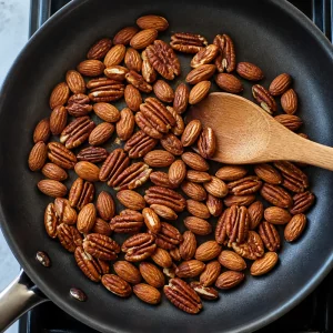 Almonds and pecans toasting in a dry skillet