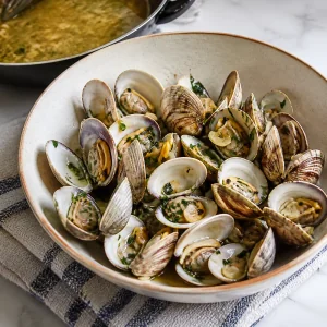 Opened steamed clams transferred to a warm serving bowl