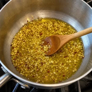 Lightly golden garlic and red pepper flakes in olive oil