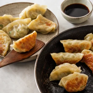 Cooked vegetable dumplings re-crisped and served with soy dipping sauce