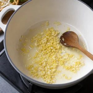 Minced ginger and garlic sauteing gently in oil