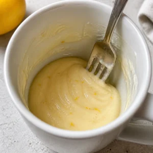 Lemon batter scraped level inside the mug