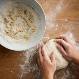 Masa de gozleme amasada junto a un bol con masa rugosa