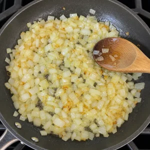 Chopped onion cooking in oil in a skillet
