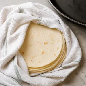 Warm tortillas wrapped in a damp towel