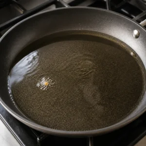 Breadcrumb sizzling in hot oil in a skillet
