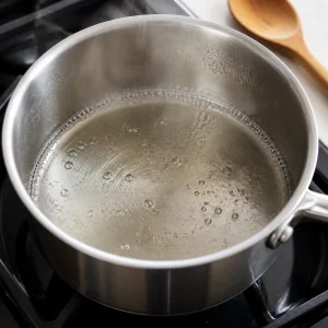 Clear simple syrup gently simmering in a saucepan
