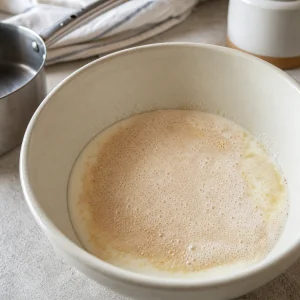 Foamy yeast blooming in warm buttermilk