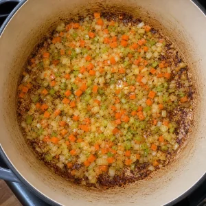 Onion, carrot, and celery cooking in the browned pot
