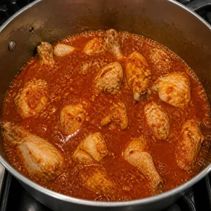 Chicken pieces simmering in red dakdoritang sauce