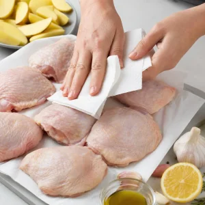 Raw chicken thighs patted dry with paper towels before roasting