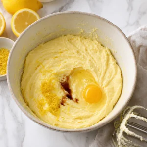 Egg, vanilla, and lemon zest added to lemon cake batter