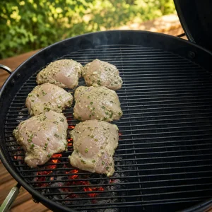 Marinated chicken thighs placed over direct heat