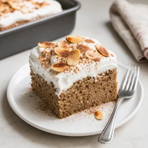 Served slice of keto tres leches cake with almonds and cinnamon.