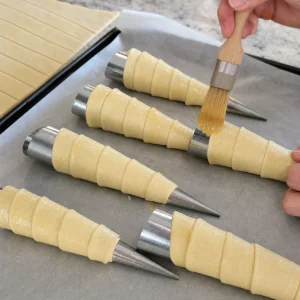 Thin dough strips wrapped around cones and brushed with butter