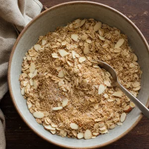 Rolled oats, sliced almonds, almond flour, coconut sugar and salt mixed in a bowl