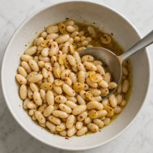 Cannellini beans folded into glossy garlic vinaigrette