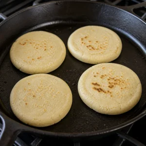 Masa rounds cooking on a dry skillet
